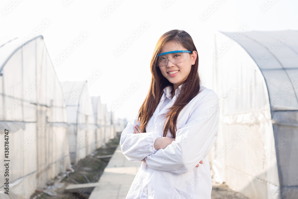 young beautiful asian woman works in green field young beautiful asian woman works in green field