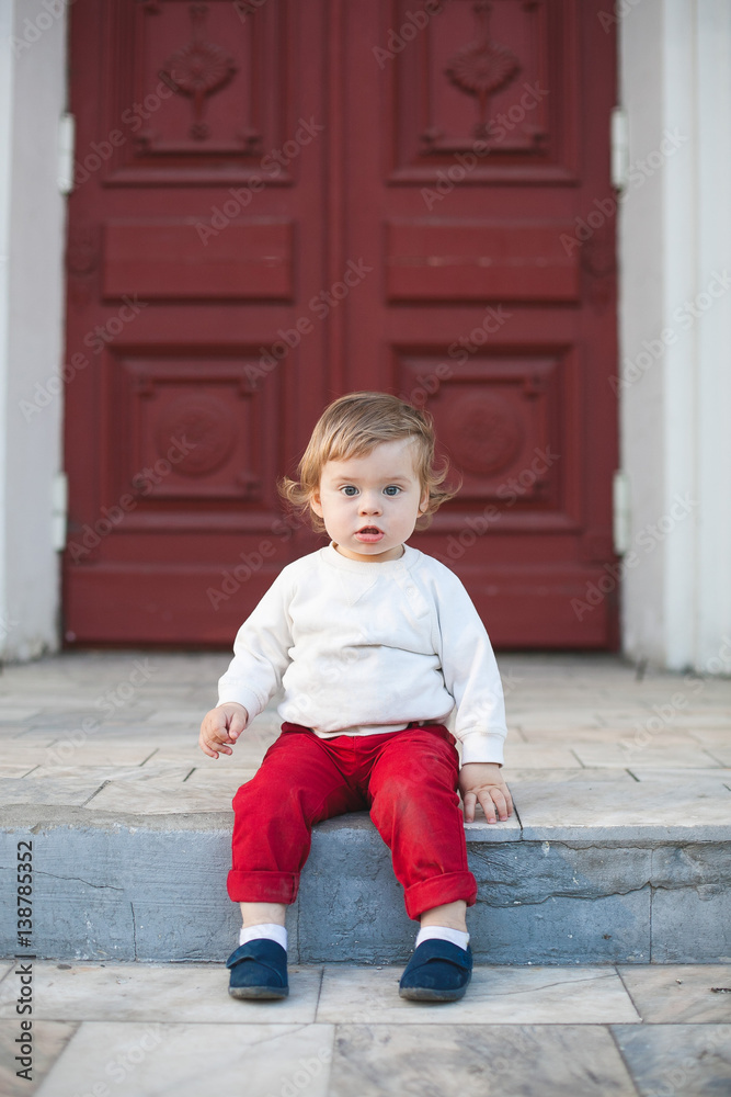 Beautiful baby boy sitting on stairs Beautiful baby boy sitting on stairs