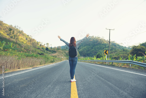 young women happy walking on the road at mounthain and sunet