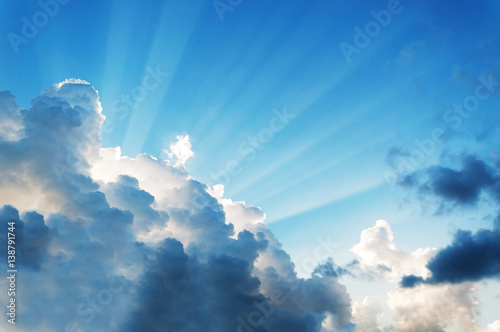 beautiful cloud on blue sky with light rays. subject is blurred and low key