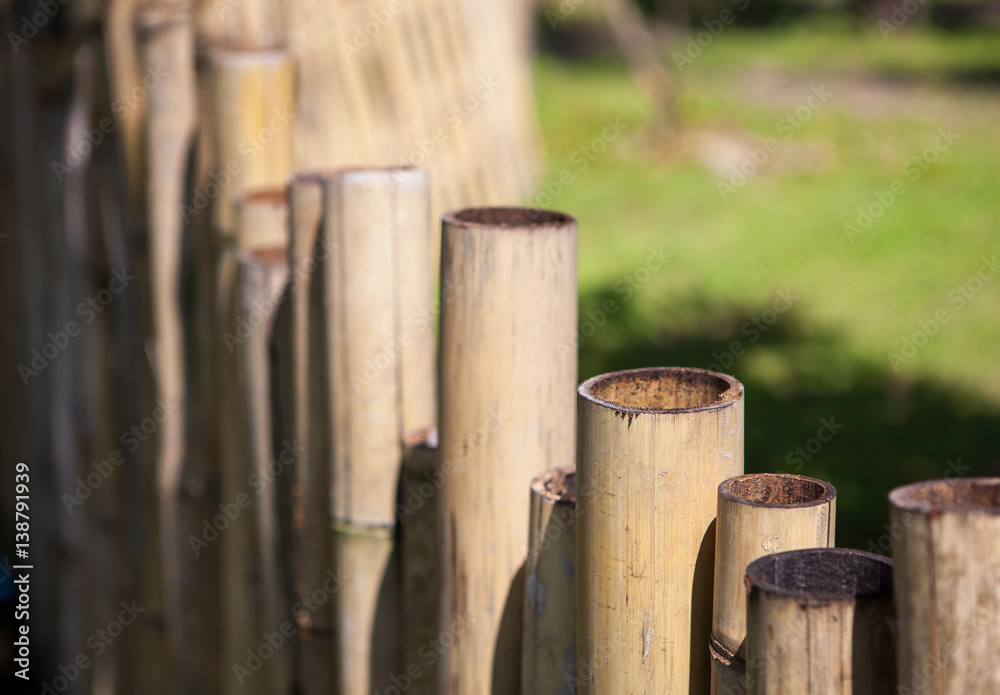 Old bamboo fence in a tropical country. Texture background Old bamboo fence in a tropical country. Texture background