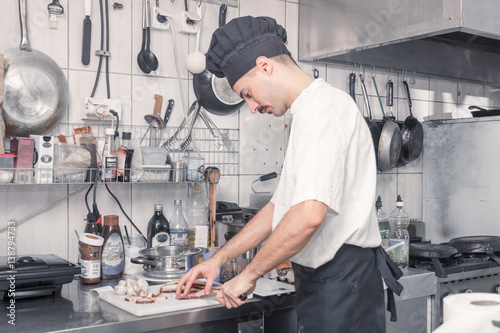 chef cutting bacon knife, professional commercial kitchen