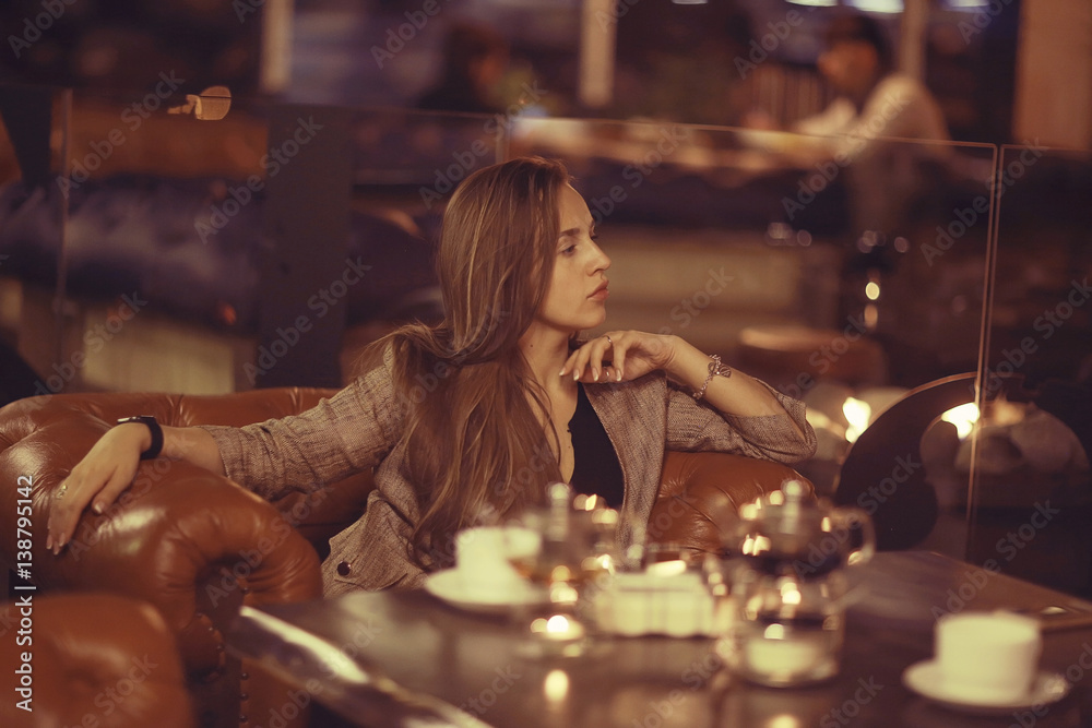 Fototapeta premium beautiful young adult girl having dinner in a restaurant