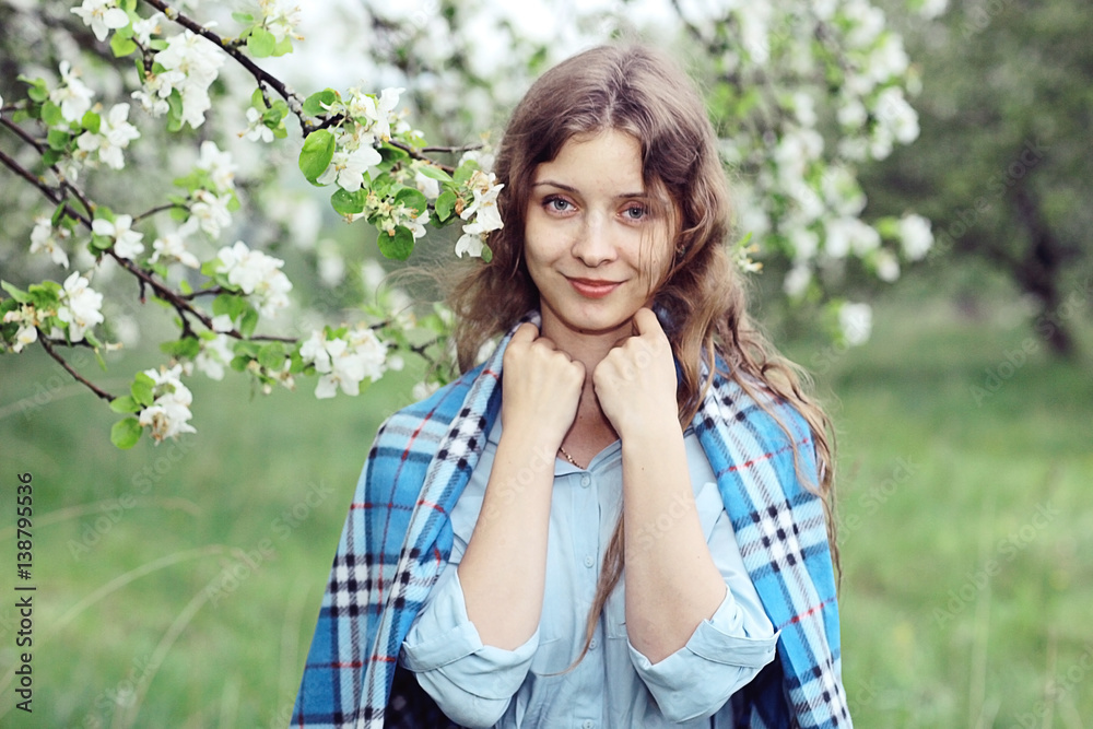 young happy woman walking in an apple orchard in the spring flowers white young happy woman walking in an apple orchard in the spring flowers white