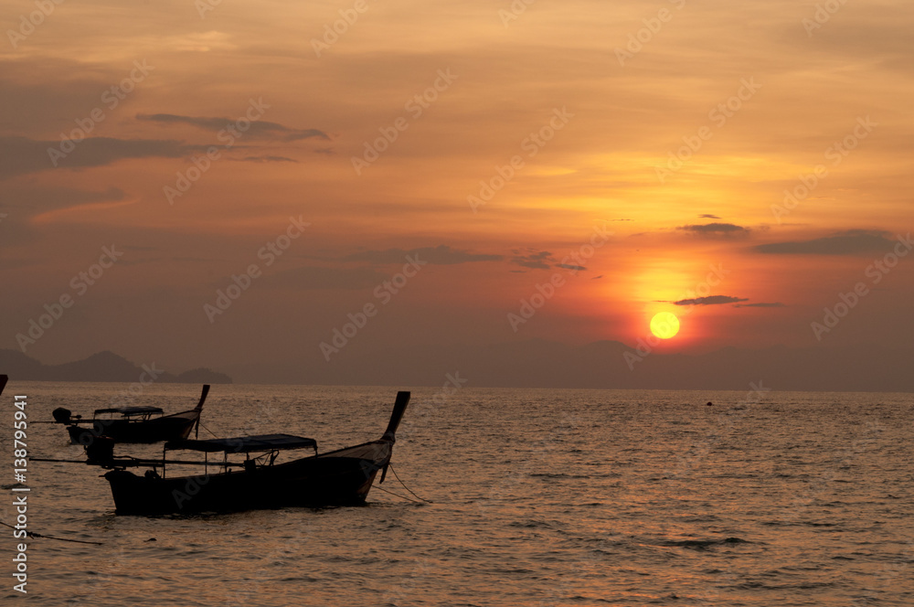 blurred of silhouette Traditional longtail boat on the sea at sunset light