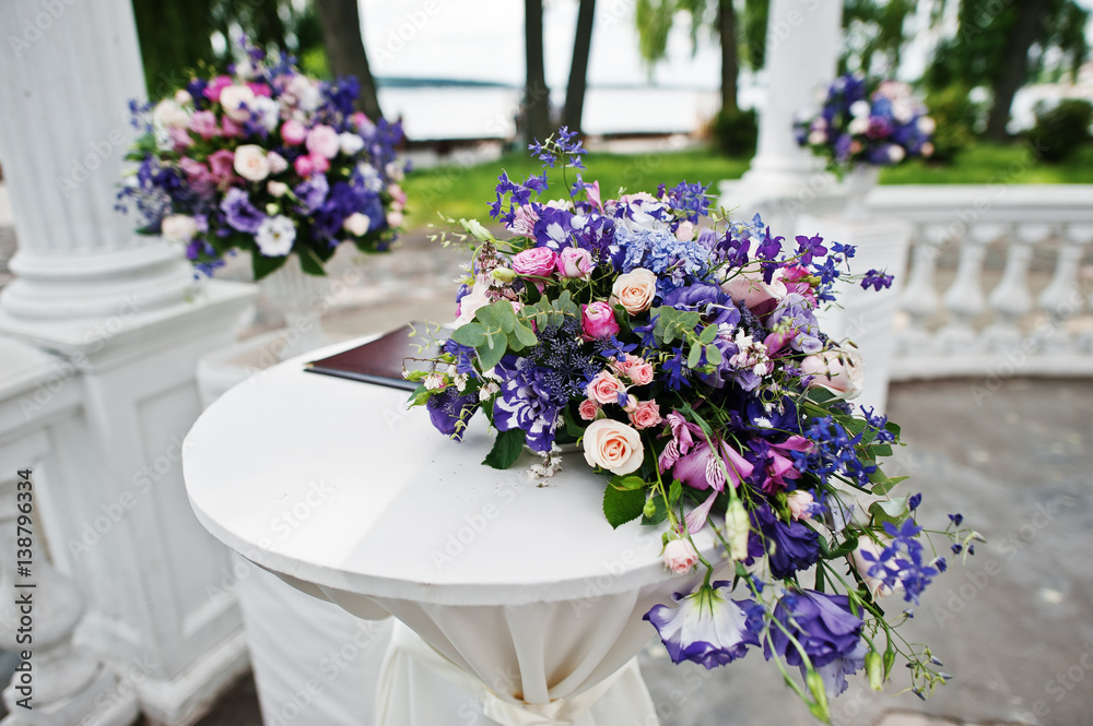 Decoration of wedding arch with registration table for newlyweds with violet and purple flowers. Decoration of wedding arch with registration table for newlyweds with violet and purple flowers.