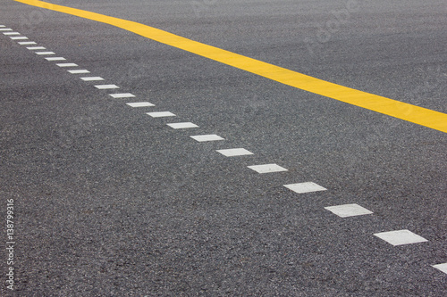 Asphalt road texture for background with yellow line