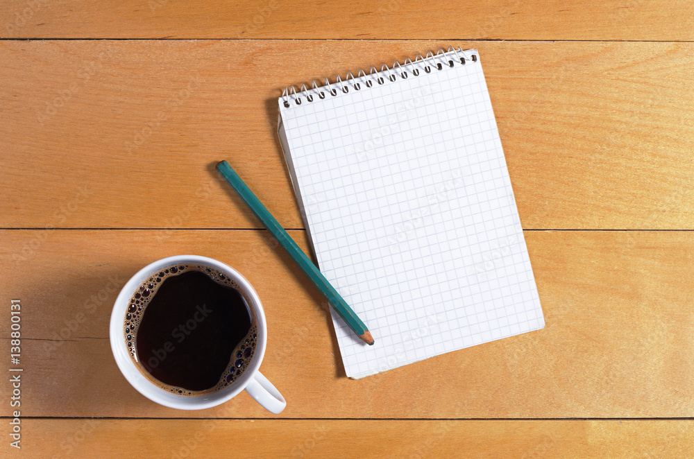 Notebook and coffee cup Notebook and coffee cup