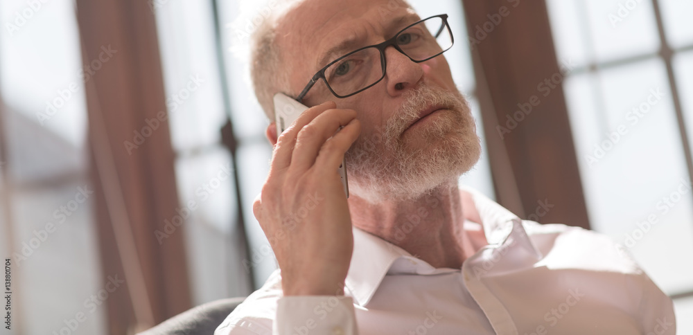 Fototapeta premium Senior man talking on phone
