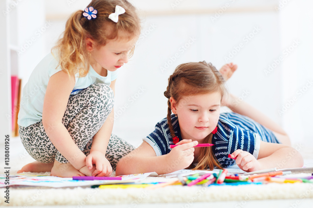 Fototapeta premium happy young girls, kids painting with felt pen together