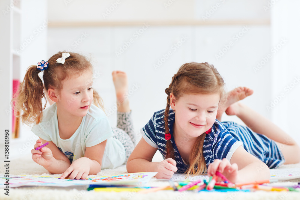happy young girls, kids painting with felt pen together happy young girls, kids painting with felt pen together