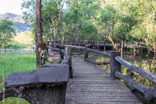Black wooden bridge on reservoir