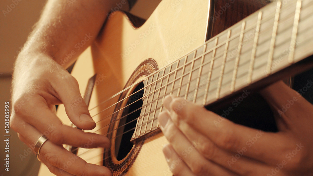 Fototapeta premium Hands of guitarist playing a guitar