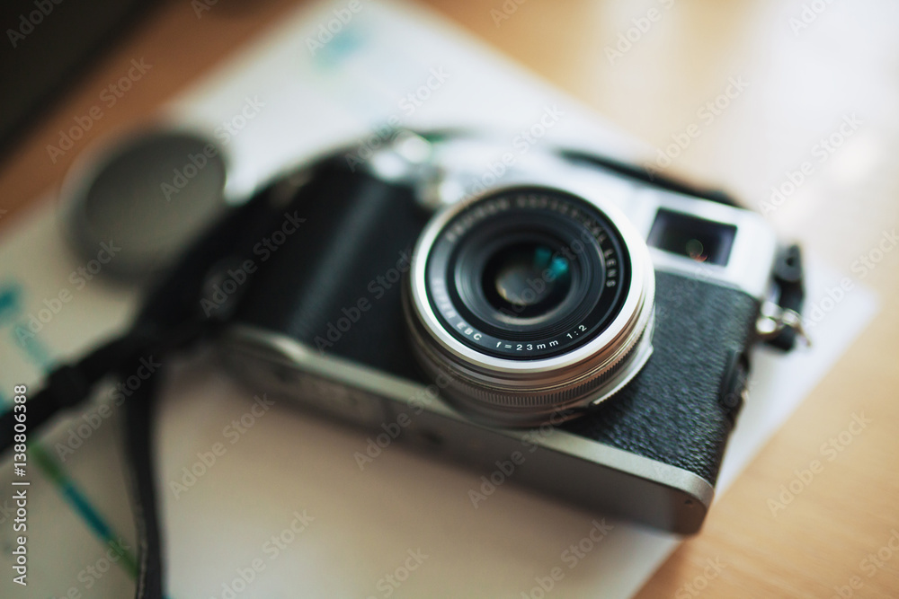 Stylish retro-looking mirrorless digital camera with lens attached