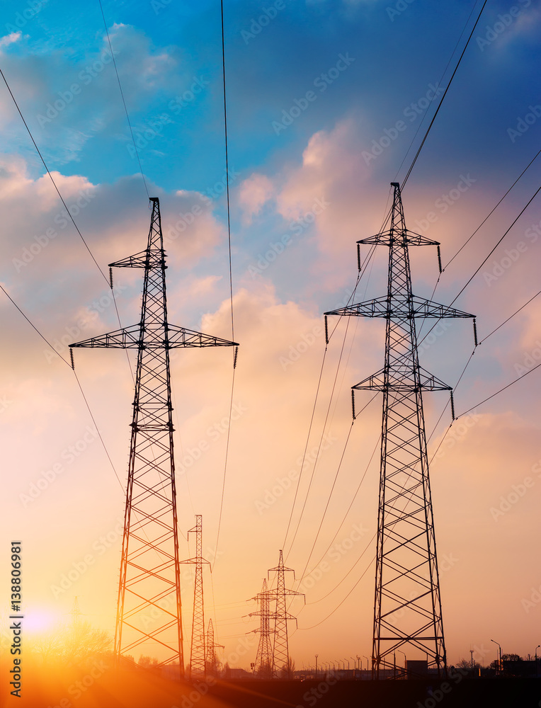 High voltage cable power post steel tower pylons in sunset scene twilight vintage color tone
