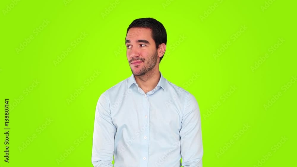 Worried young businessman against green background Worried young businessman against green background