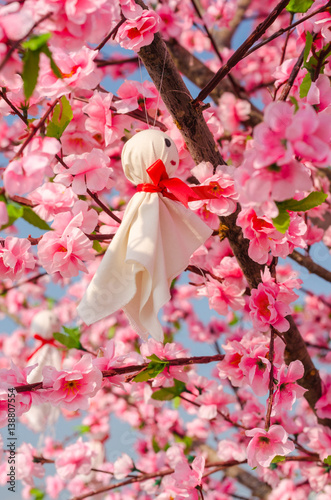 Teru teru bozu or Japanese Rain Doll hanging on Sakura tree