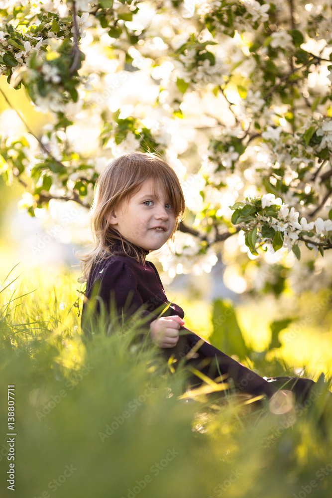 Baby girl and spring flowers, childhood emotions