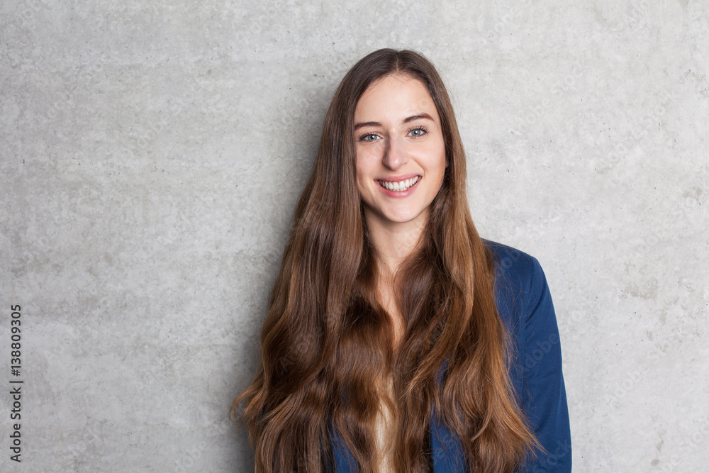 young business woman in front of concrete wall young business woman in front of concrete wall