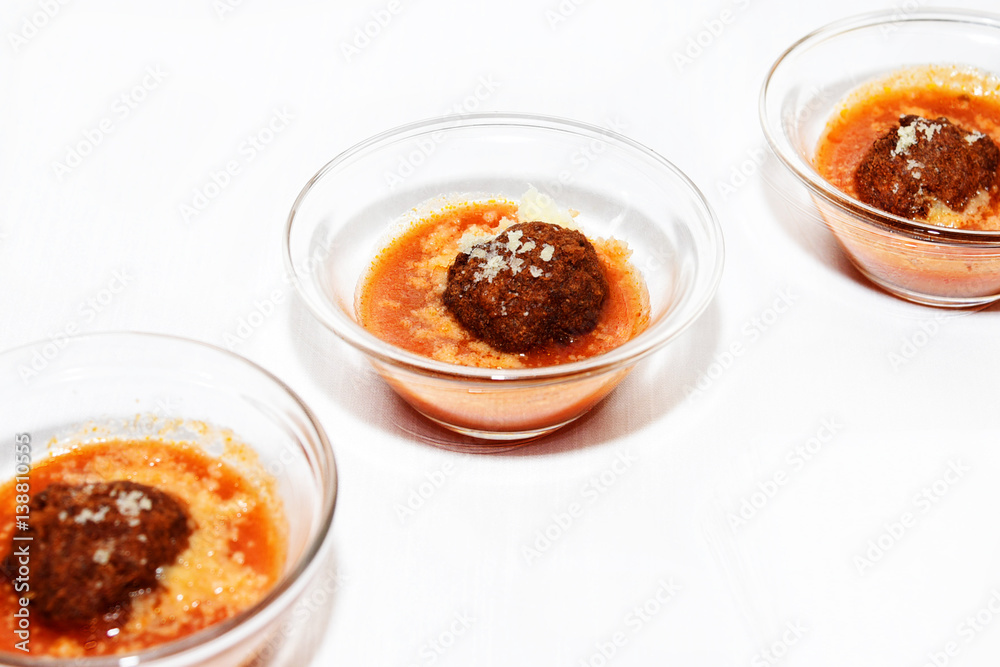 meatballs with tomato sauce, single portion in small glass bowls meatballs with tomato sauce, single portion in small glass bowls