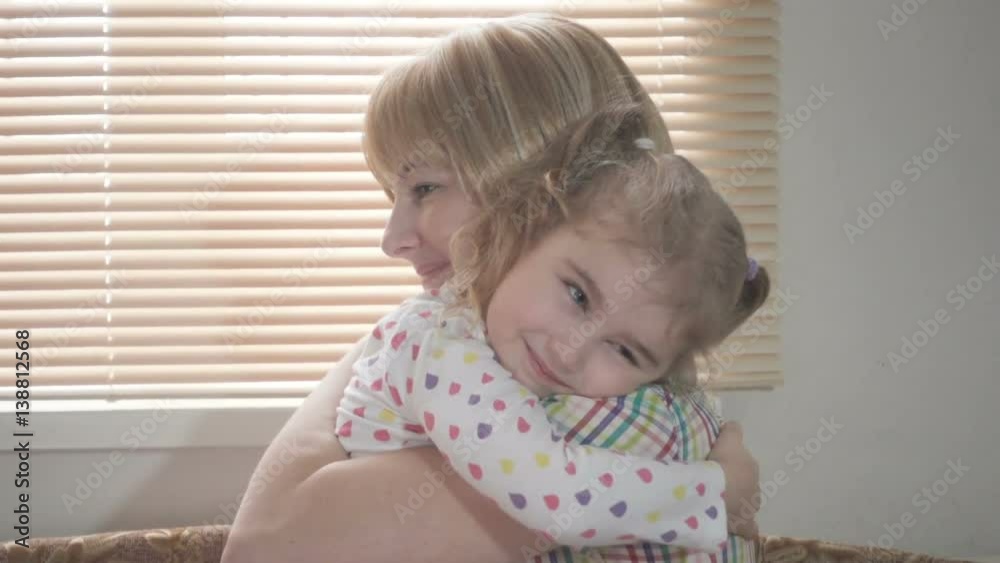 Daughter Rushes Into Mother's Arms At Home Across From the Window. Slow motion. Big Hug