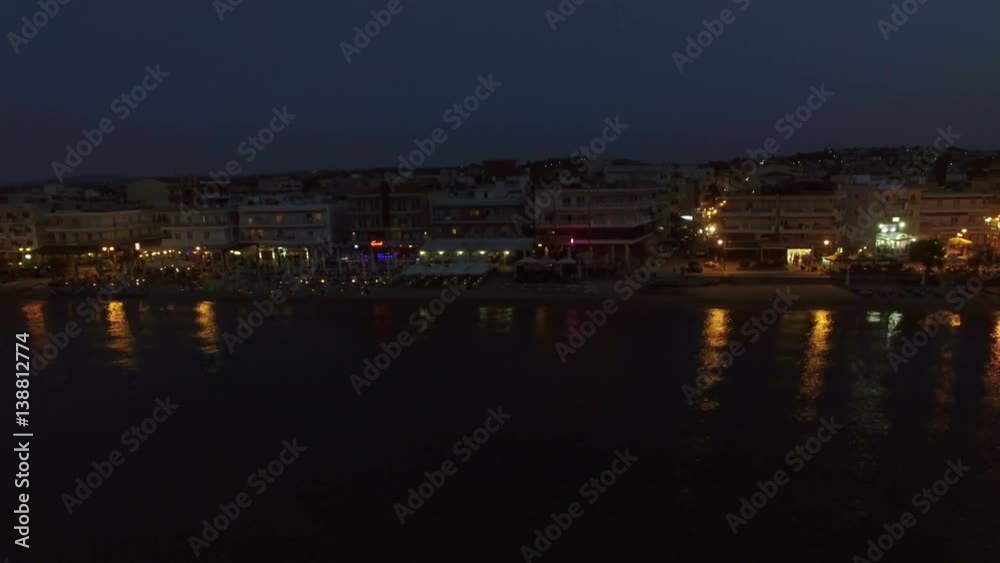 Aerial night shot of the coast with hotels, cafes, and chaise-longues alongside. Resort in Thessaloniki, Greece Aerial night shot of the coast with hotels, cafes, and chaise-longues alongside. Resort in Thessaloniki, Greece