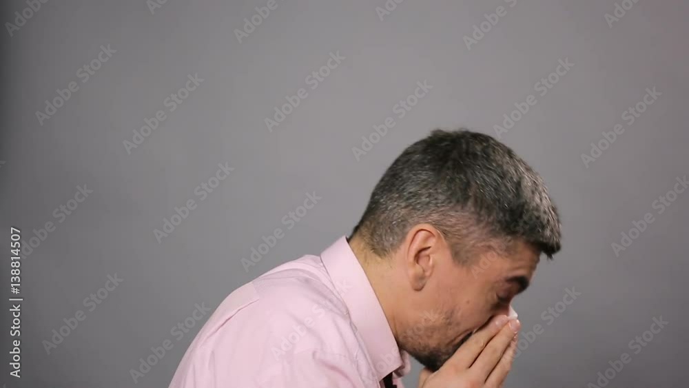 Allergy, rhinitis, sickness. Diseased male sneezing and wiping nose with tissue Allergy, rhinitis, sickness. Diseased male sneezing and wiping nose with tissue