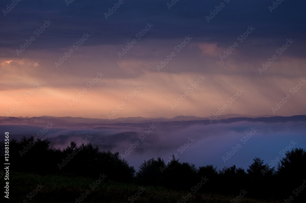 Fototapeta premium Rainy morning landscape. Mist, rain and dark clouds natural scenery