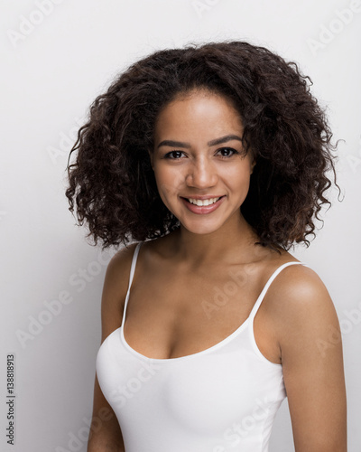 Beauty portrait of a smiling brunette woman, looking at camera