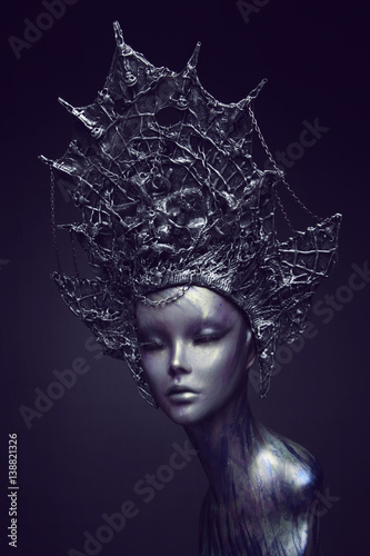 Mannequin in metallic headwear with chains photo