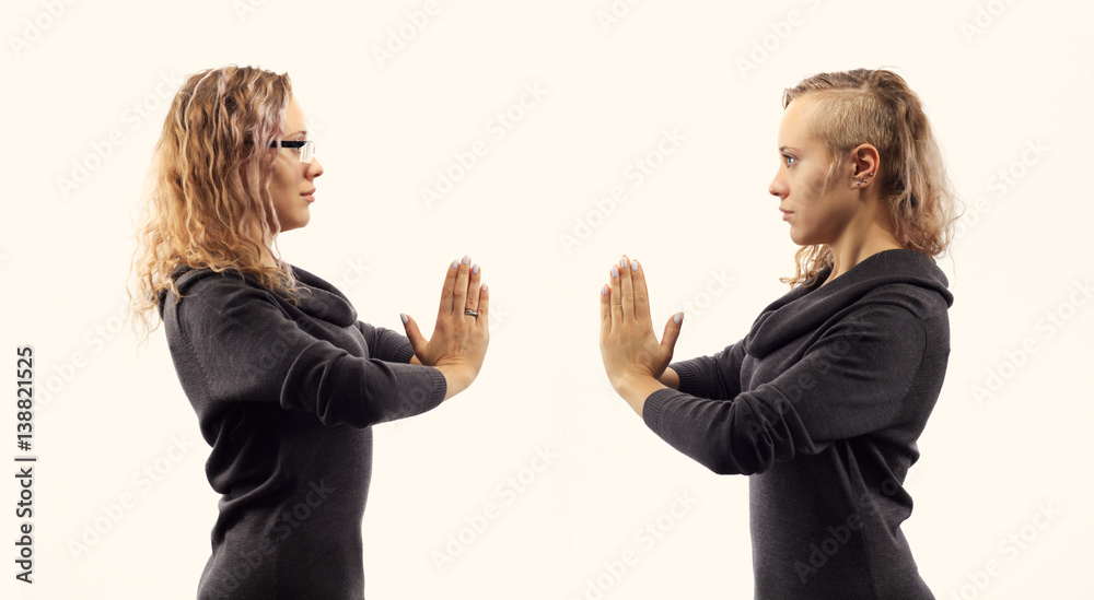 Self talk concept. Young woman talking to herself, showing gestures. Double portrait from two different side views. Self talk concept. Young woman talking to herself, showing gestures. Double portrait from two different side views.