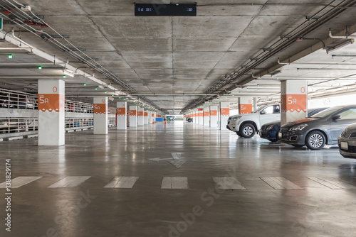 interior of parking garage with car and vacant parking lot