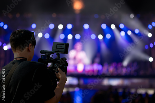 Covering an event on stage with a video camera. © redkphotohobby