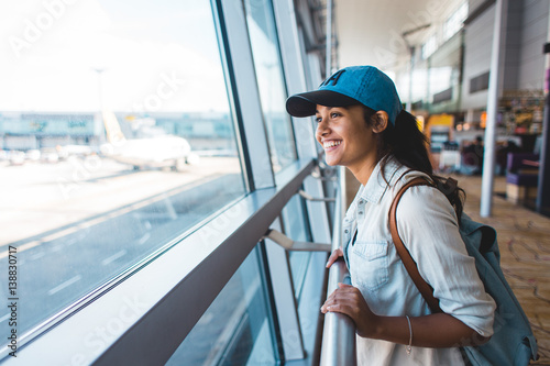 Photos Young woman at airport waiting for airplane