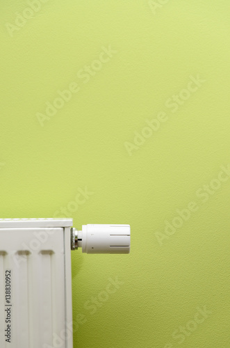 radiator valve on green background with negative space