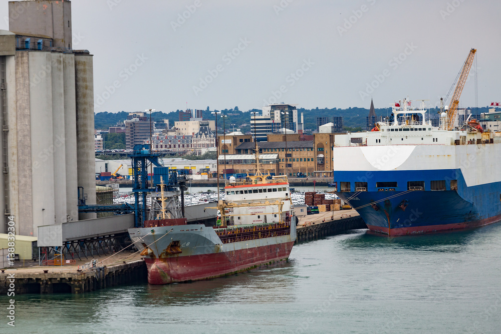 Huge and Small Freighter in Port Huge and Small Freighter in Port