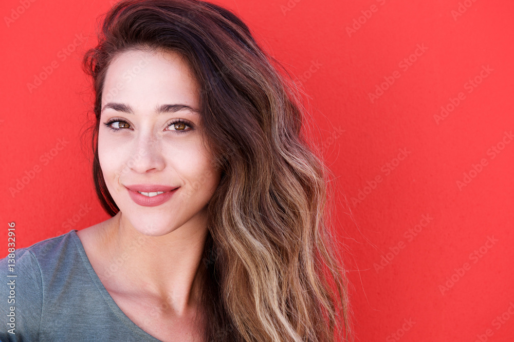 young smiling woman against red background young smiling woman against red background