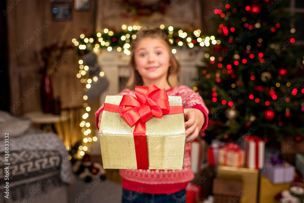 Happy kid showing gift box Happy kid showing gift box
