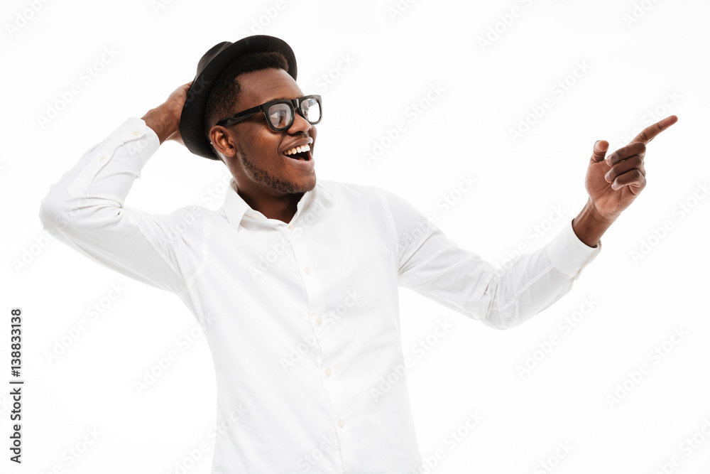 Young african man looking aside and pointing. Young african man looking aside and pointing.