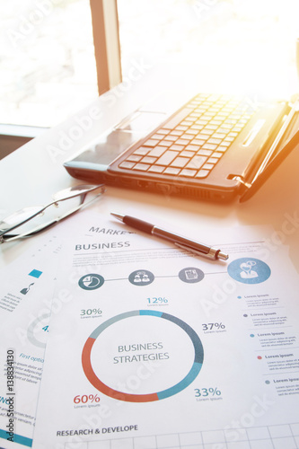 Wallpaper Mural business documents on office table with laptop computer and graph financial diagram and Business people working at office Torontodigital.ca