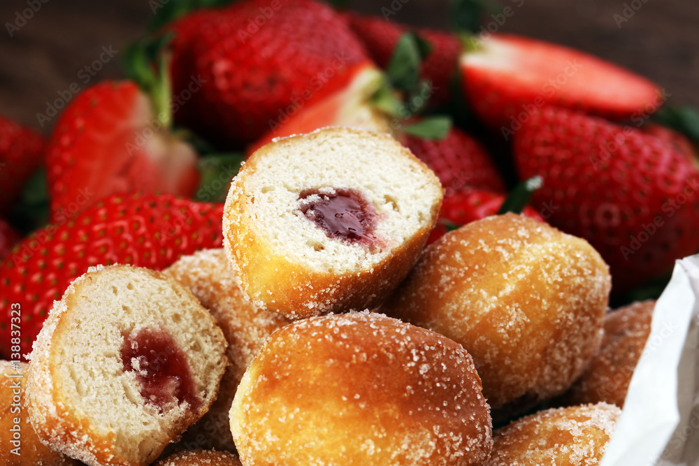 Bomboloni - traditional Italian doughnuts stuffed with strawberry jam