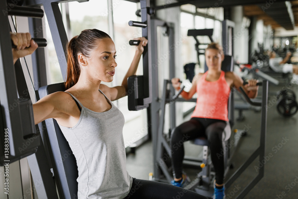 Woman working out in gym on machine Woman working out in gym on machine