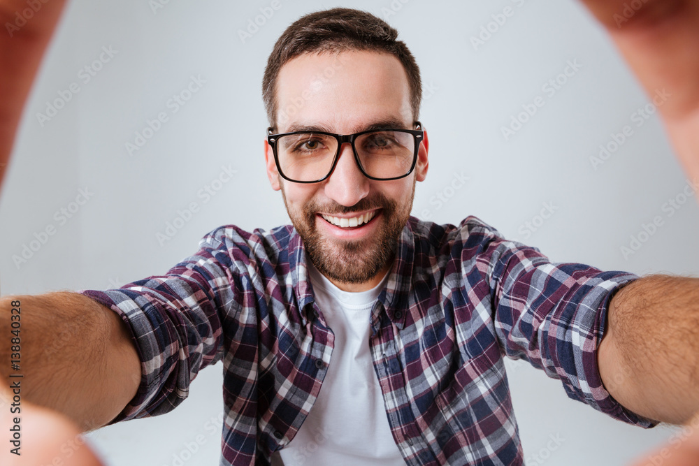 Portrait of Young Bearded man in eyeglases making selfie Portrait of Young Bearded man in eyeglases making selfie