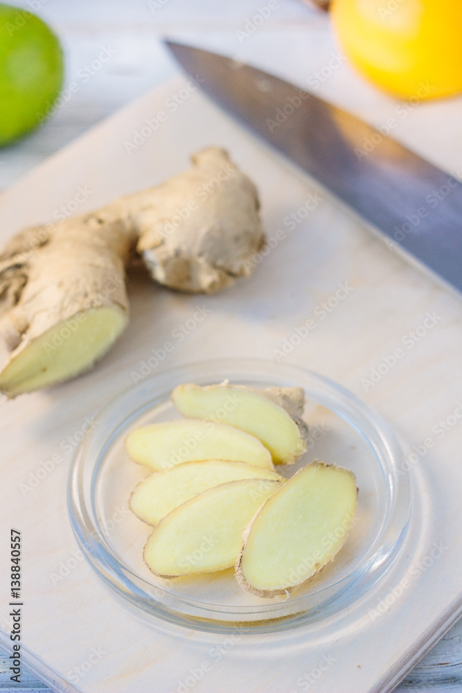 Ginger root slices on transparent glass plate. Ginger root slices on transparent glass plate.