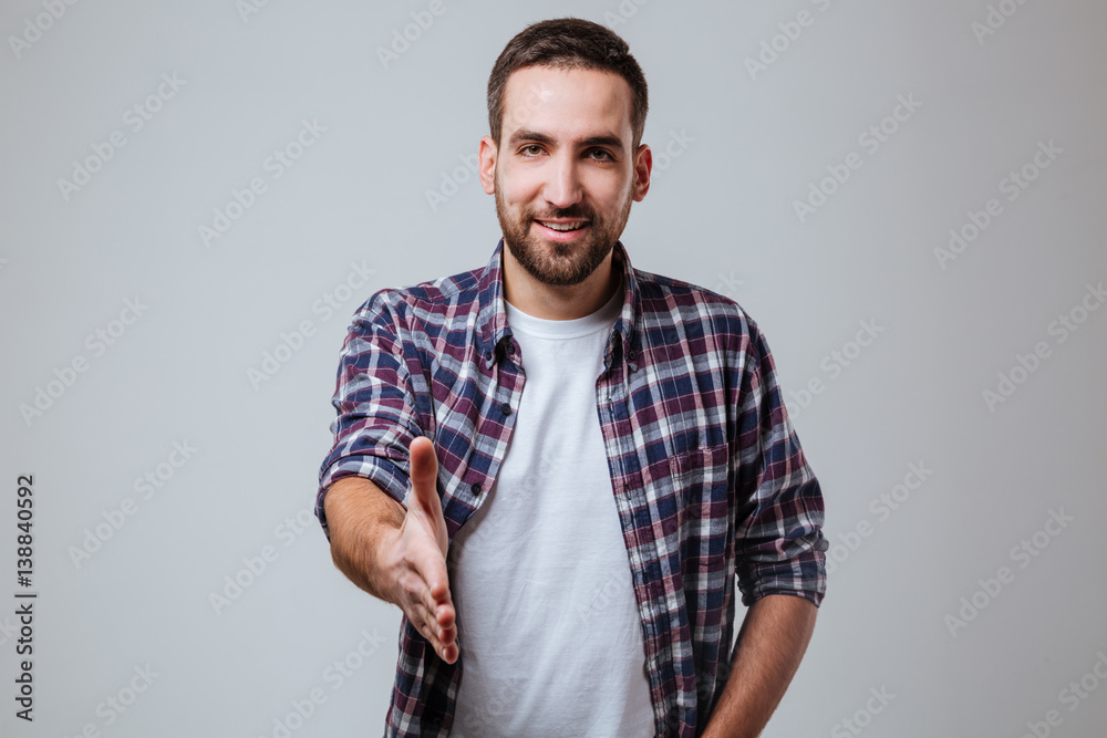 Bearded man in shirt extends the hand Bearded man in shirt extends the hand