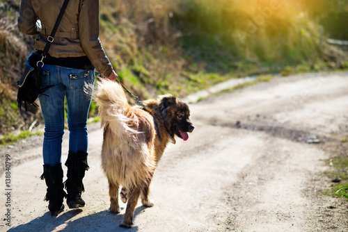 Girl playing with Caucasian shepherd dog, autumn