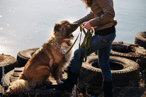 Girl playing with Caucasian shepherd dog, autumn photo