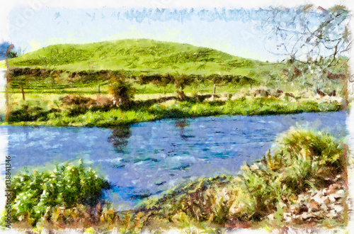 River flowing through a meadow with a grassy hillock in the background