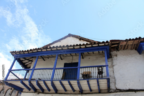 Blue wooden balcony of an old colonial house in Cuzco, Peru.