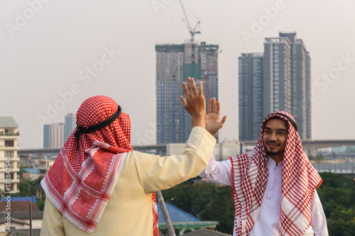 Successful Arabic business people on cityscape background